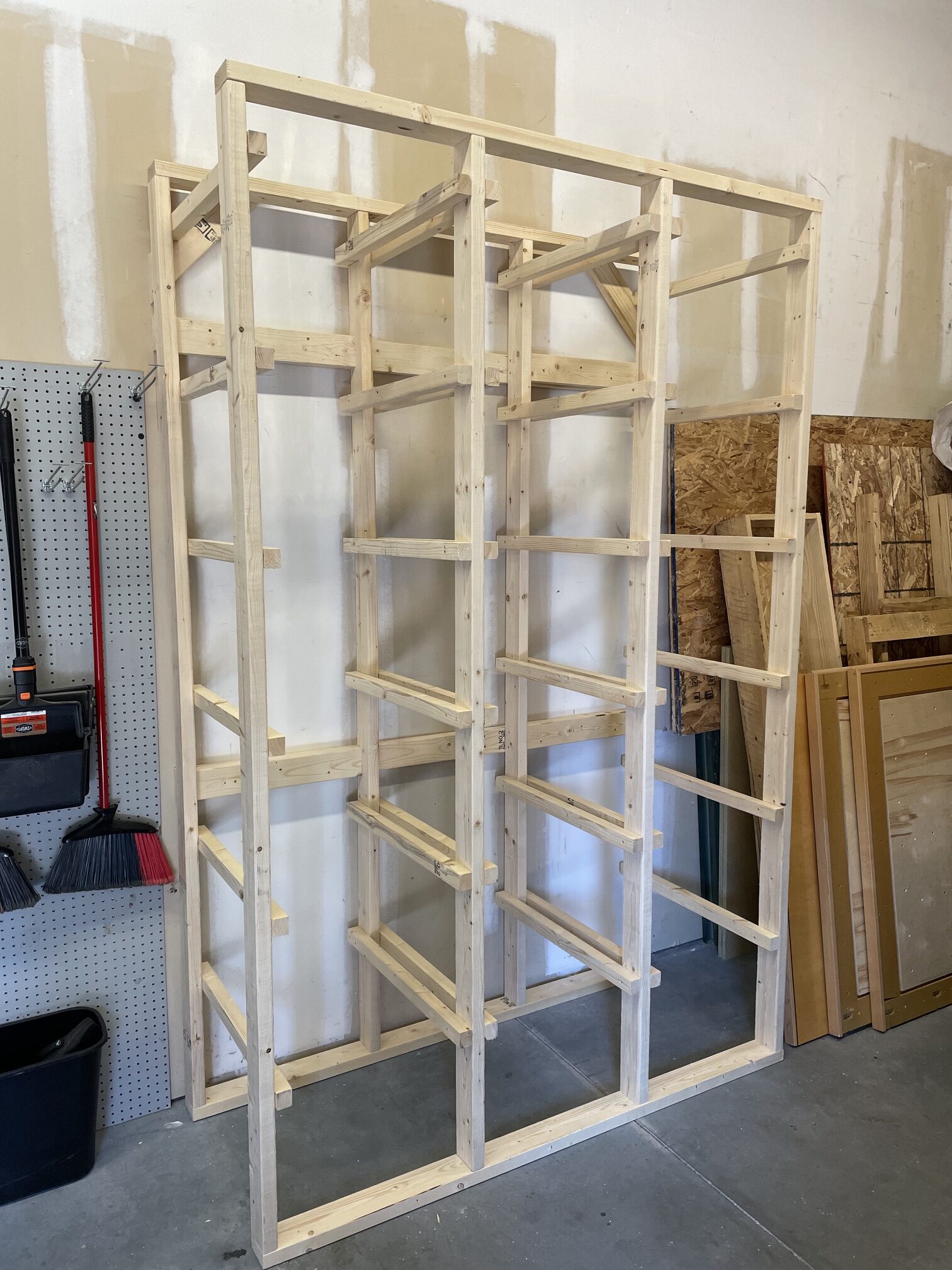 Custom tall wood storage rack installed in commercial space — Bull City Handyman Durham NC