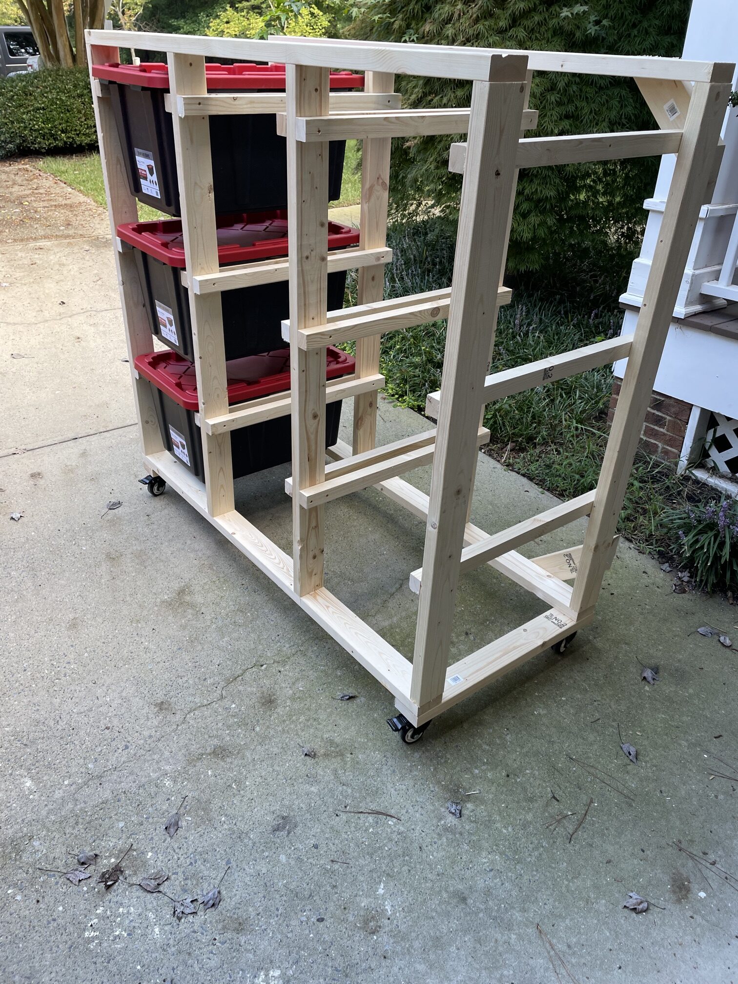 Custom wood garage storage rack on casters with red storage totes — Durham NC