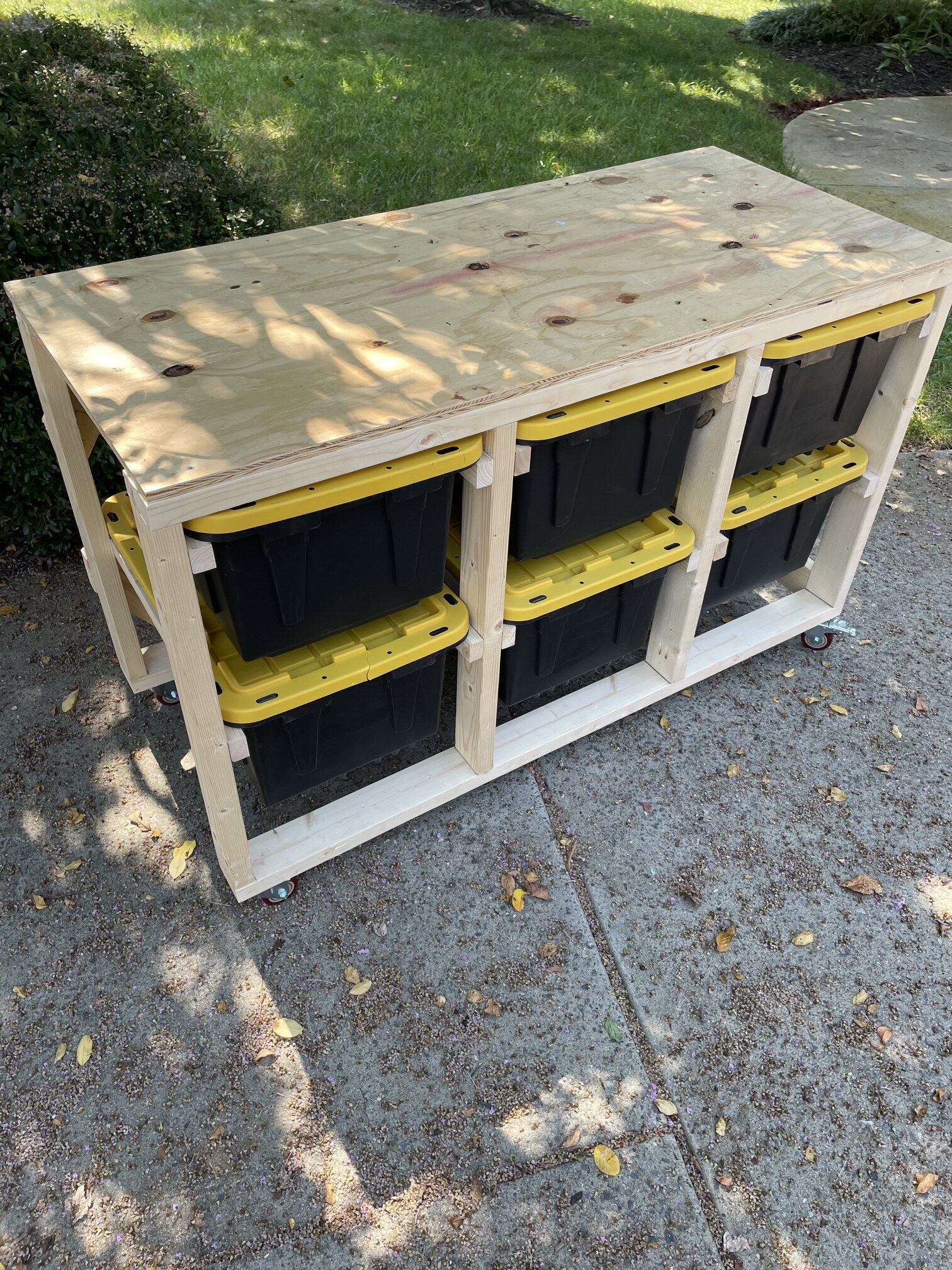 Custom wood garage storage system with workshop top and storage totes — Durham NC
