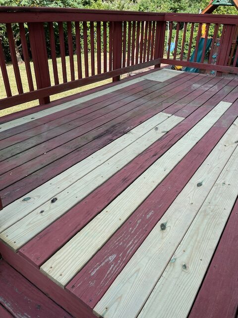 New pressure-treated deck boards installed next to existing stained deck boards