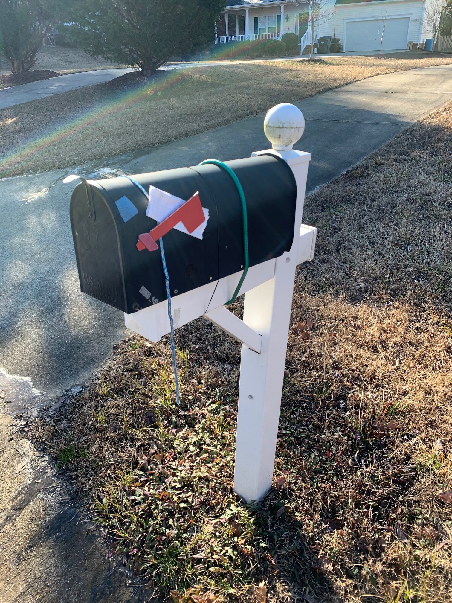 Mailbox held on with bungee cords before repair in Durham NC